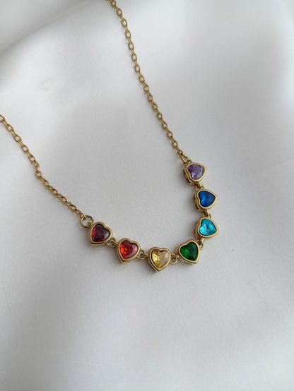Necklace with heart-shaped colorful gemstones on a white background